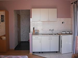 Kuchyň nebo kuchyňský kout v ubytování Apartments & Rooms Tony