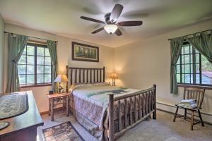 a bedroom with a bed and a ceiling fan at Lake Placid Chalet Deck and Forest Views! in Lake Placid