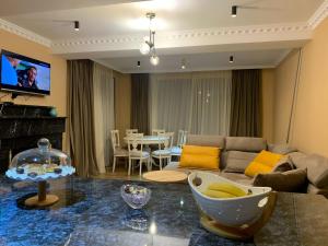 a living room with a couch and a table at Green Mountain Borjomi in Borjomi