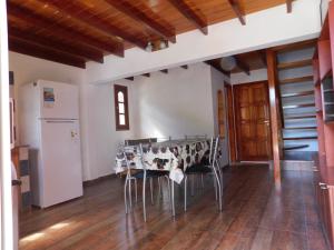 a kitchen with a table and chairs in a room at Alquileres Luis in San Clemente del Tuyú