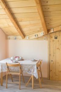 a dining room table with a white tablecloth and chairs at Irina in Soko Banja