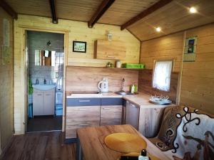 a kitchen in a log cabin with a table at Zielona Dolina Hoczew in Hoczew