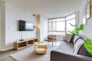 a living room with a couch and a table at Wonderful 1 Bedroom Condo At Ballston With Gym in Arlington