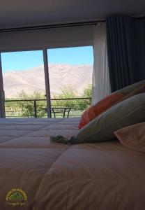 a bedroom with a bed with a view of the desert at Pircas De Arboleda in Salamanca