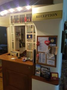 an office with a reception desk and a sign that reads reception at Ada Apartments in Sarajevo