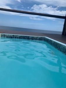 a swimming pool with a view of the ocean at Mozambique,Inhambane,Barra -Entire Beach House in Inhambane