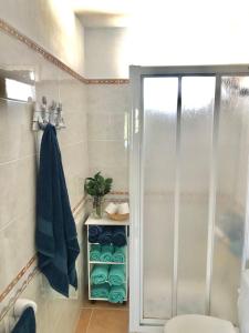 a bathroom with a shower and a toilet and a towel at Casa La Galera (Playa a 50 metros) in Corralejo