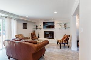 a living room with a couch and chairs and a fireplace at Peaceful Pintail in Ocean Pines