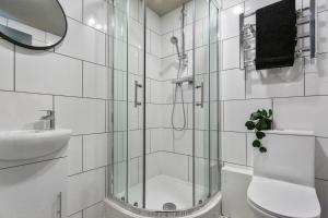 a bathroom with a shower and a toilet and a sink at BKT Aparthotel Coventry in Coventry