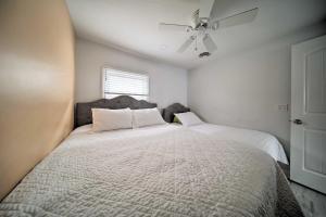 a bedroom with two beds and a ceiling fan at Sunny, Modern Waterfront Cottage with Grill in Erie! in Erie