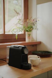 a coffee maker and a cup on a table at Secluded Holiday Home with Sauna in National Park by the Sea in Vaide