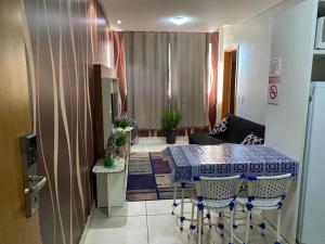 a living room with a table and chairs in a room at Everest Flat Service - Apartamento 301 in Caldas Novas