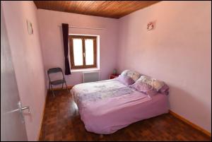 a small bedroom with a bed and a window at Doudou Vercors in Lans-en-Vercors