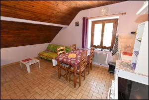 a living room with a table and a couch at Doudou Vercors in Lans-en-Vercors
