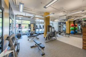 a gym with several treadmills and cardio machines at Amazing 2BR Condo At Crystal City With Rooftop in Arlington