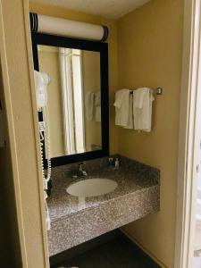 a bathroom with a sink and a mirror at BlissPoint Inn Northwest Indianapolis in Indianapolis