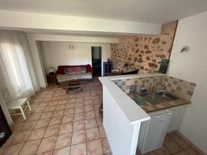 a kitchen and living room with a table and a couch at C&O Appartements in Comigne +28 photos