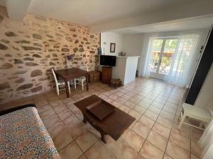 a living room with a table and a dining room at C&O Appartements in Comigne