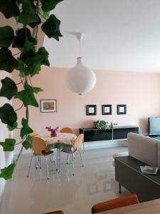 a living room with a table and chairs at Elena's Hotel & apartments in Sarandë