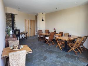 a dining room with wooden tables and chairs at Villa Alva Guest House in Coja