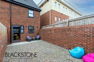 a brick wall with a blackstone sign in front of a building at Island House - 3 Bedroom Townhouse by BPNE in Darlington