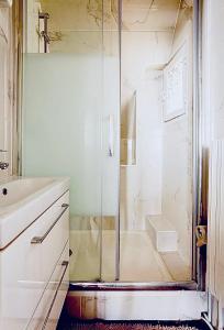 a bathroom with a shower with a sink and a toilet at Beautiful apartment with a view of Eiffel Tower in center Paris in Paris