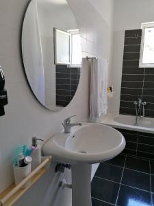 a bathroom with a sink and a mirror at Elena's Hotel & apartments in Sarandë +44 photos