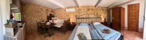 a bedroom with a large bed and a table at Finca Es Velar in Santanyi