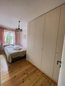 a bedroom with a bed and a large closet at Ratuszowa 18 in Olsztynek
