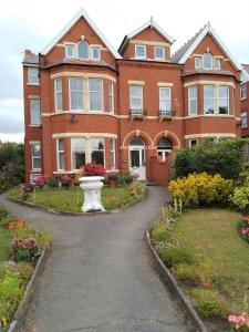 a large brick house with a vase in the driveway at St Anne's Lodge Apartments Penthouse with Seaview, Lytham St Anne's in Lytham St Annes