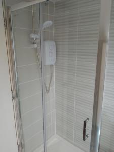 a bathroom with a shower with a glass door at St Anne's Lodge Apartments Penthouse with Seaview, Lytham St Anne's in Lytham St Annes