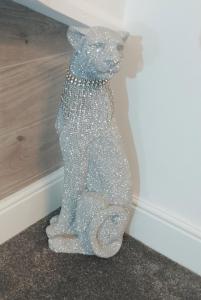 a teddy bear covered in glitter sitting next to a wall at St Anne's Lodge Apartments Penthouse with Seaview, Lytham St Anne's in Lytham St Annes
