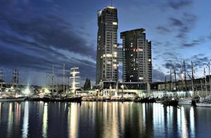 a marina with many boats in the water at night at Sea Towers Apartament 27 z Tarasem in Gdynia
