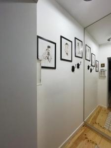 a room with a white wall with pictures on it at Ratuszowa 18 in Olsztynek