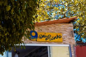 a yellow sign on the side of a building at Pousada Mar do Sonho Vila in Porto De Galinhas