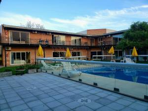 a hotel with a swimming pool in front of a building at Marvic Hotel in San Pedro