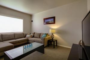 a living room with a couch and a table at Reardon Place in Port Fairy