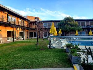 a resort with a pool and chairs and umbrellas at Marvic Hotel in San Pedro