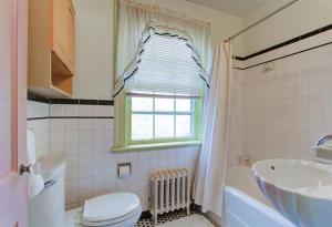 a bathroom with a toilet and a sink and a window at Home Sweet Home, Suite #2, near Liberty University, and Lynchburg Hospital, Deluxe Queen Size Bedroom in Lynchburg