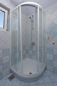 a shower with a glass enclosure in a bathroom at Double Room Vrbnik 5299c in Vrbnik