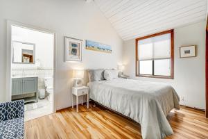 a white bedroom with a bed and a bathroom at Blue Horizon in Bodega Bay