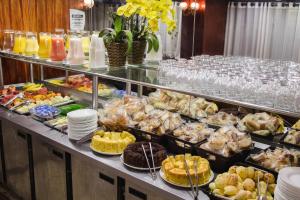 un buffet con muchos tipos diferentes de comida y bebida en Hotel Nacional Inn Belo Horizonte, en Belo Horizonte