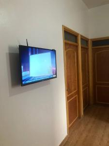 a flat screen tv hanging on a wall at Dar hanae tanger in Tangier +11 photos