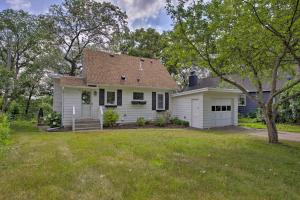 a white house with a garage and a yard at Cozy Plymouth Cottage with Medicine Lake View! in Minneapolis