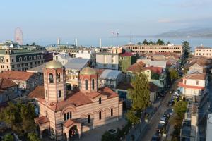 an aerial view of a city with a church at Piazza Four Colours in Batumi