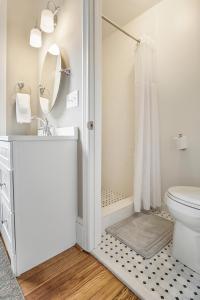 a white bathroom with a toilet and a shower at Liberty Hall Bed and Breakfast in Pendleton