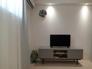 a flat screen tv sitting on top of a entertainment center at Apartment Valbandon 7296b in Štinjan