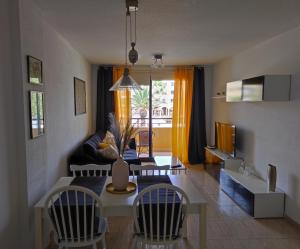 een woonkamer met een tafel en stoelen en een bank bij Sweet Lola in El Médano