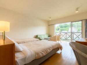 Postelja oz. postelje v sobi nastanitve Tabist Villa Daio Resort Ise-Shima