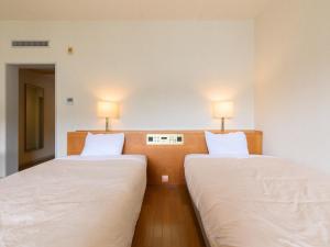 Postelja oz. postelje v sobi nastanitve Tabist Villa Daio Resort Ise-Shima